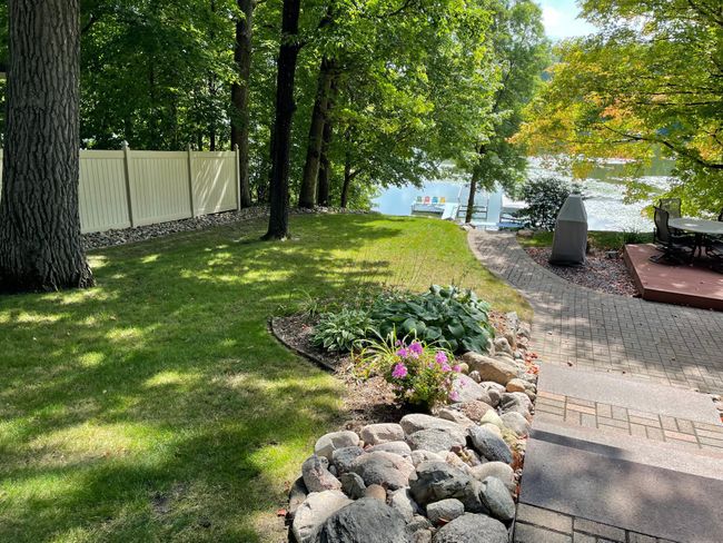 Stone staircase to the lake. An underground irrigation system keeps the lawn green and lush all summer. | Image 18