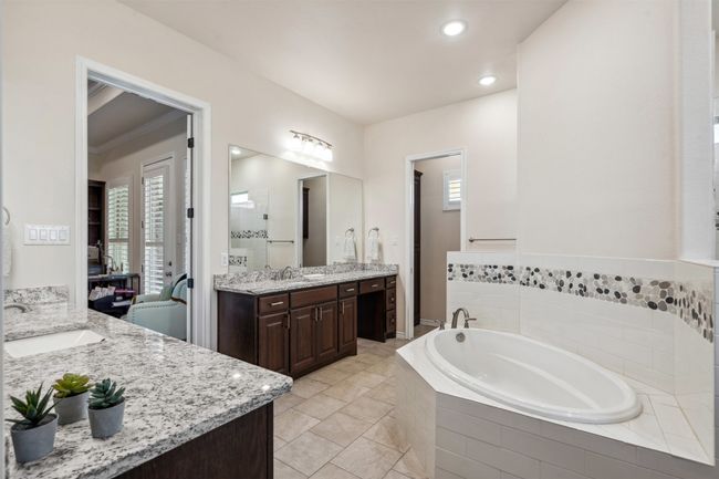 Bathroom with a garden tub, two vanities, a sink, and recessed lighting | Image 26