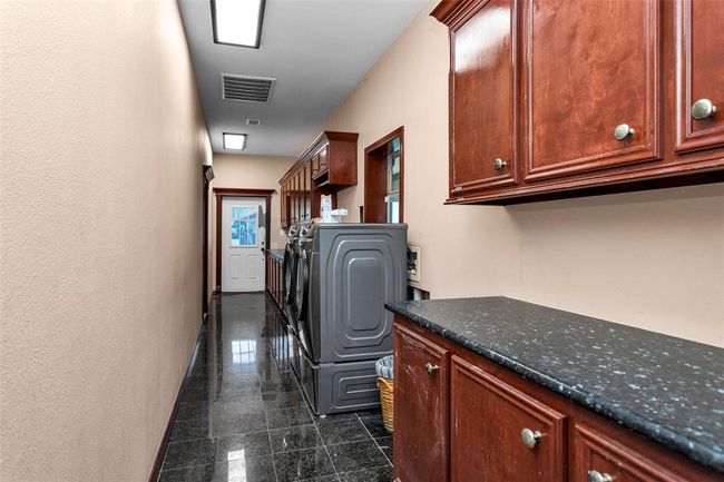 Laundry room with countertops to fold on | Image 24