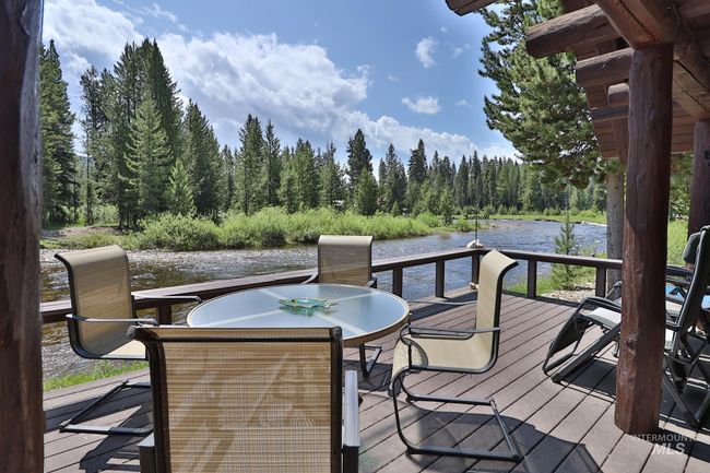 Deck featuring a water view, a wooded view, and outdoor dining space | Image 15