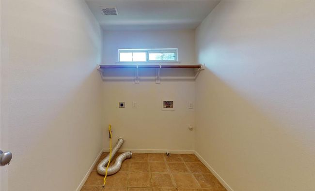 Convenient upstairs utility room with ample space for laundry and storage needs. | Image 39