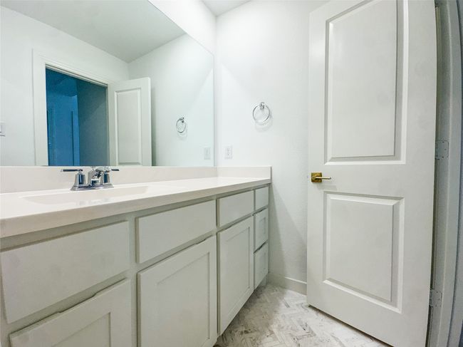 Bathroom with vanity and marble look tile flooring | Image 25