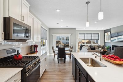 (Photo of decorated model, finishes will vary) Soaked in natural sunlight, the homes eat-in dining room has ample space for a dining table located in the heart of the home. | Image 3