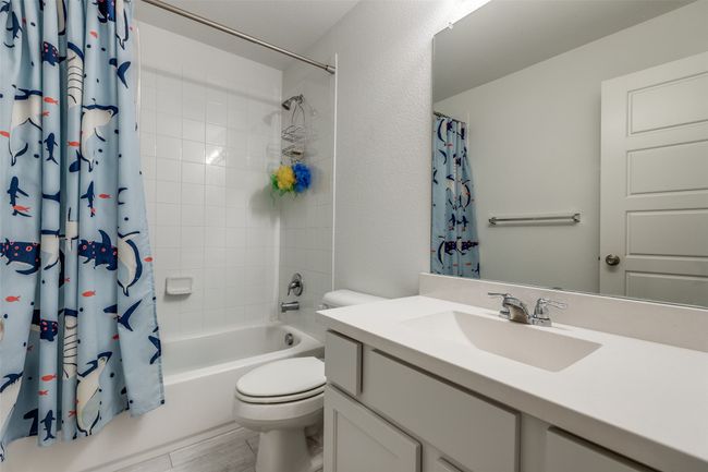 Bathroom featuring toilet, vanity, and shower / bath combo with shower curtain | Image 14