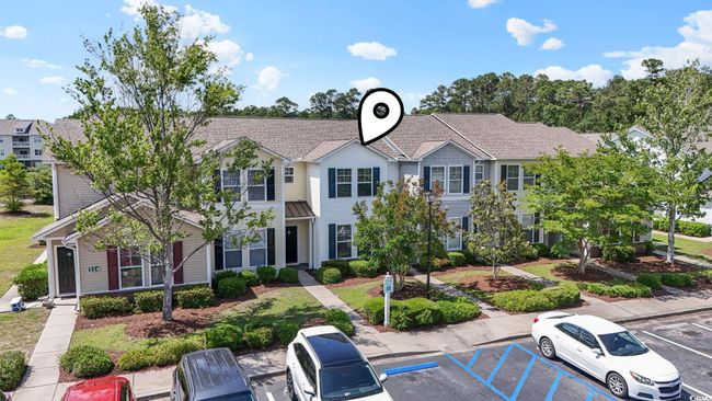 View of front facade with a standing seam roof, uncovered parking, metal roof, and roof with shingles | Image 31