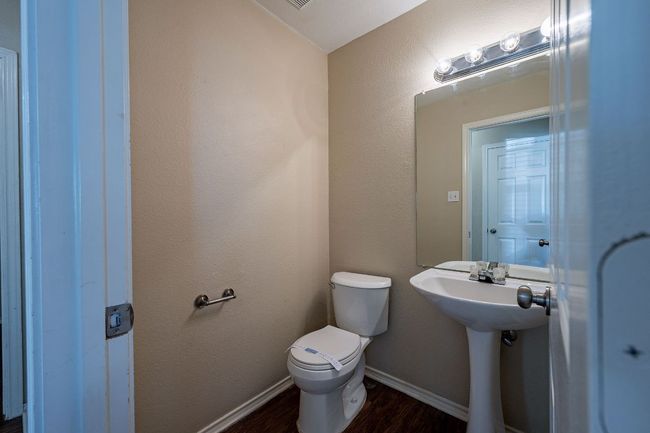 Bathroom featuring wood finished floors, toilet, and baseboards | Image 22