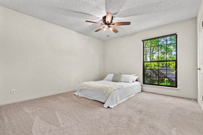 The primary bedroom offers a quiet and private retreat, separate from the other bedrooms in the house. | Image 17