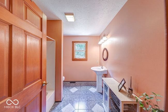 full bathroom with granite floors, bathing tub / shower combination, and a textured ceiling | Image 36