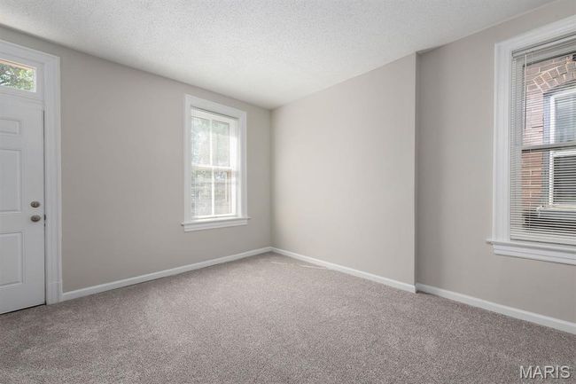 Carpeted spare room with plenty of natural light and a textured ceiling | Image 13