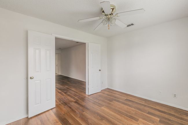 Unfurnished room featuring ceiling fan, wood finished floors, and baseboards | Image 21