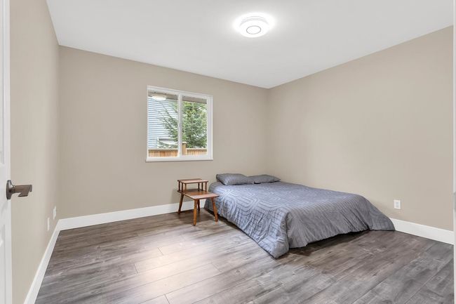 Bedroom with baseboards and wood finished floors | Image 22