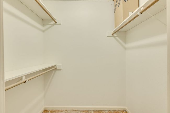 View of walk in closet in primary bedroom. | Image 22