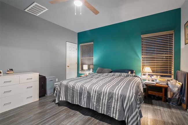 Spacious primary suite on the back of the house for added privacy offers a walk in closet, dual vanities, linen closet plus a window over the shower and tub providing natural light. | Image 21