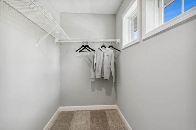 (Photo of decorated model, similar floor plan, colors, finishes and features will vary) The spacious closet featured in the secondary bedroom. | Image 22