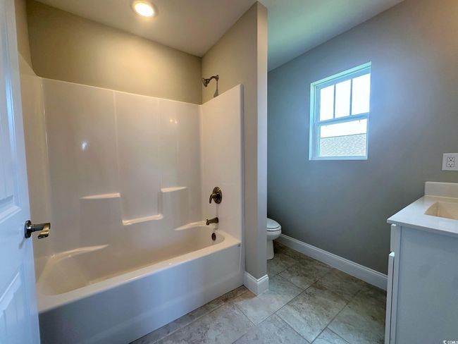 Additional living space with carpet, baseboards, vaulted ceiling, and ceiling fan | Image 16