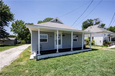 Bungalow-style house with a front lawn | Image 1