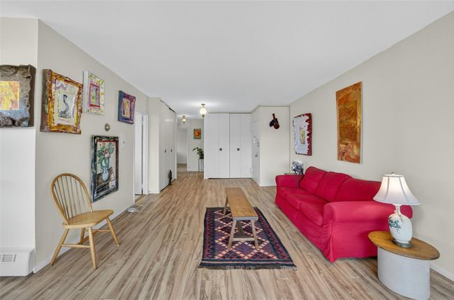 Living room with wood finished floors and baseboards | Image 5