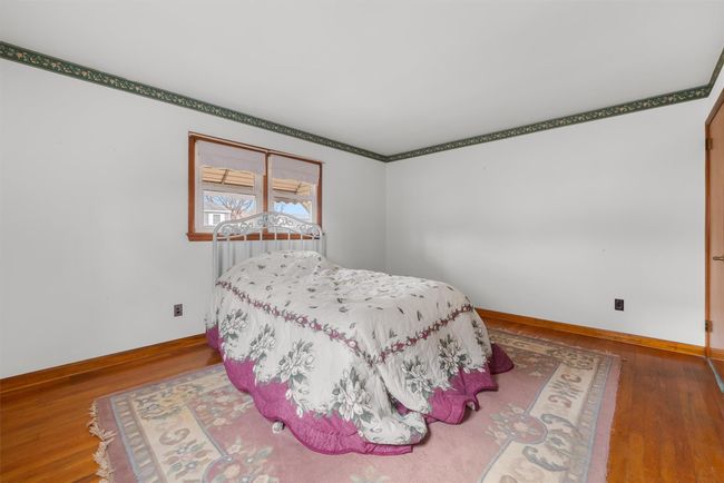 Bedroom featuring baseboards and wood finished floors | Image 25