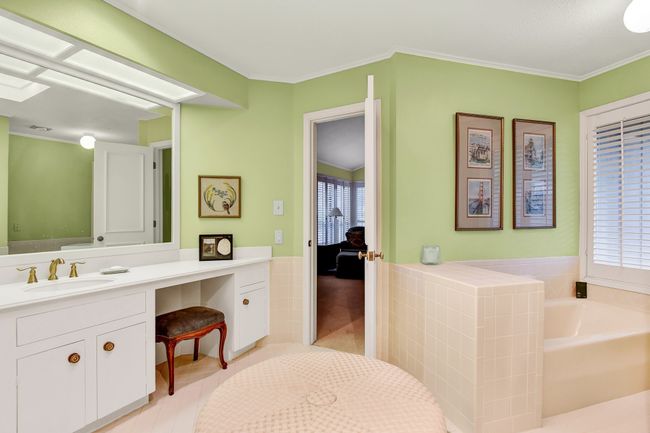 Full bathroom featuring vanity, a garden tub, plenty of natural light, tile patterned flooring, and crown molding | Image 25