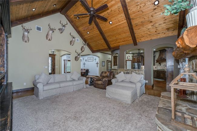 Living area featuring high vaulted ceiling, ceiling fan, arched walkways, wooden ceiling | Image 11