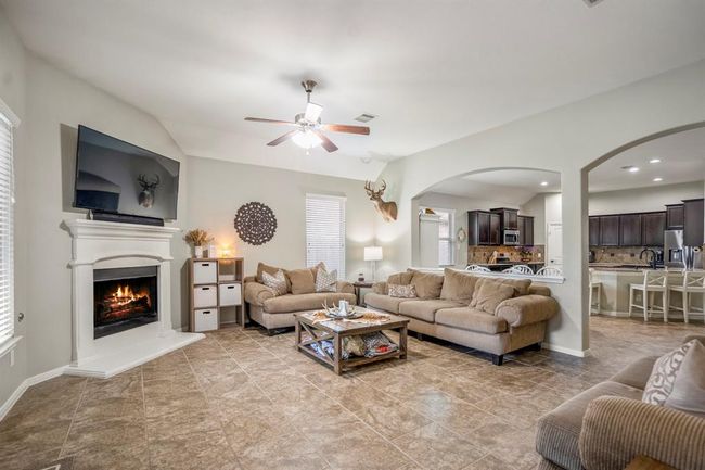 From the back door, enjoy a clear view through graceful arched openings into the dining area and kitchen—an open layout that still offers defined, inviting spaces. | Image 15