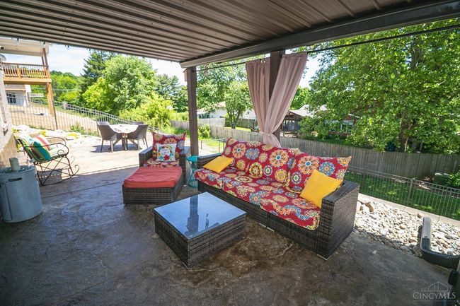 View of patio; encapsulated ceiling with gutter system. Enjoy the outdoors even in a rain storm! | Image 44