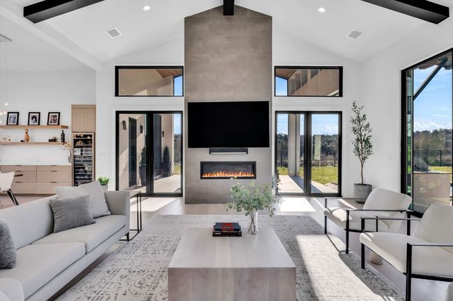 Living area features a fireplace and doors leading to pool and patio | Image 15