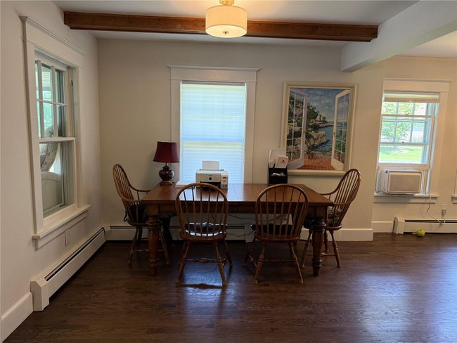 Dining room with beamed ceiling, dark wood-type flooring, and cooling unit | Image 4