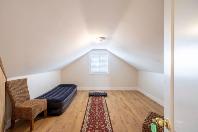 Interior space with vaulted ceiling, baseboards, and light wood-type flooring | Image 21