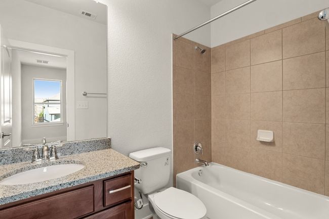 Full bath featuring shower / bathtub combination, visible vents, toilet, and vanity | Image 24