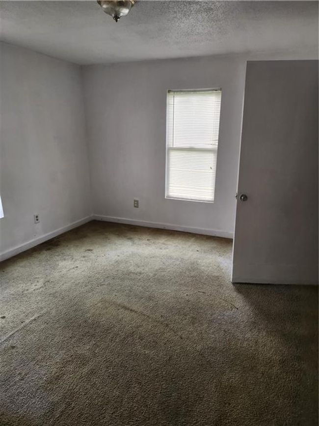 Carpeted spare room featuring a textured ceiling | Image 5