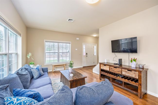 Living area with light wood-style flooring, visible vents, and a wealth of natural light | Image 6