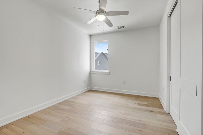 Unfurnished bedroom featuring baseboards, light wood-style floors, a closet, and a ceiling fan | Image 20