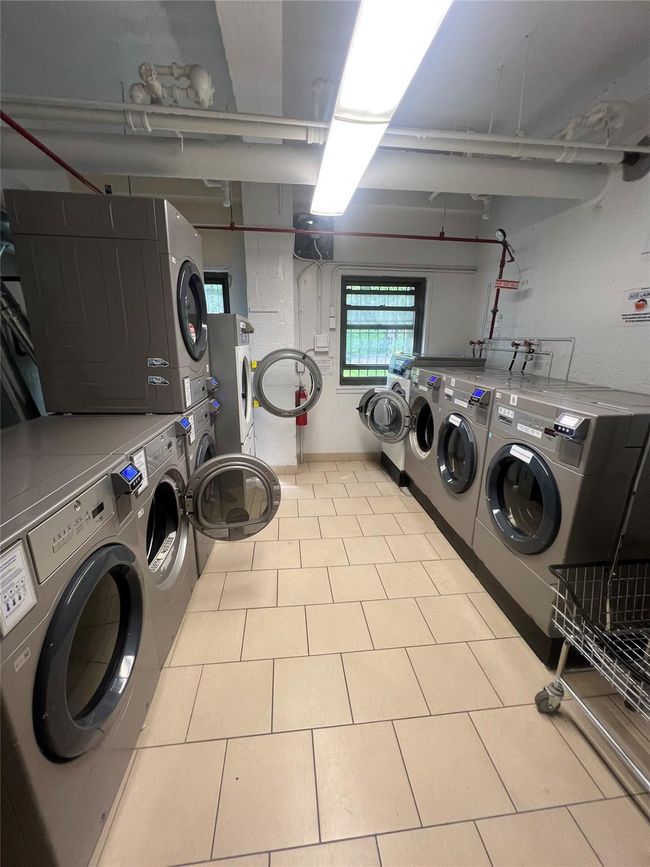 Shared laundry room with dryer and washer and dryer | Image 14