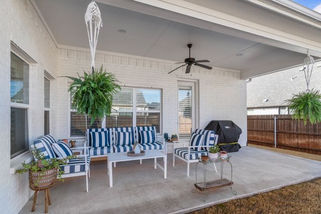 View of patio featuring a ceiling fan, area for grilling, fence, and outdoor lounge area | Image 23