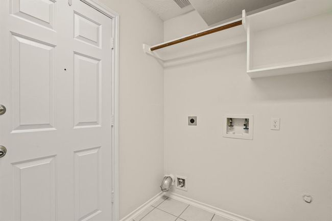 Convenient laundry room with direct garage access. | Image 17