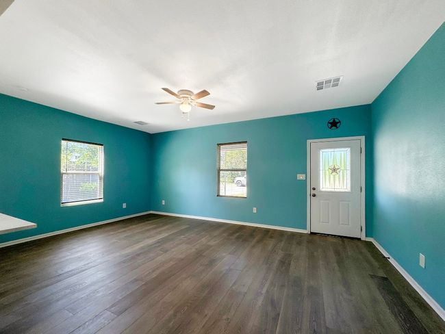 Foyer entrance with ceiling fan, dark wood-type flooring, and baseboards | Image 8