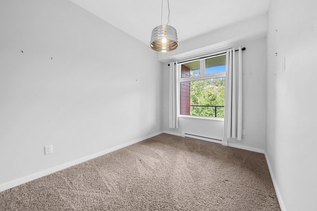 Unfurnished room with baseboard heating, carpet floors, and baseboards | Image 33