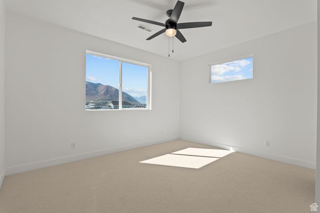 Unfurnished room with carpet floors, a mountain view, and ceiling fan | Image 33
