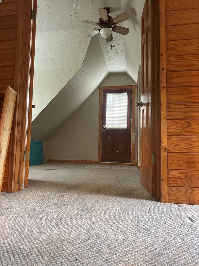 Additional living space featuring carpet flooring, vaulted ceiling, and a ceiling fan | Image 10