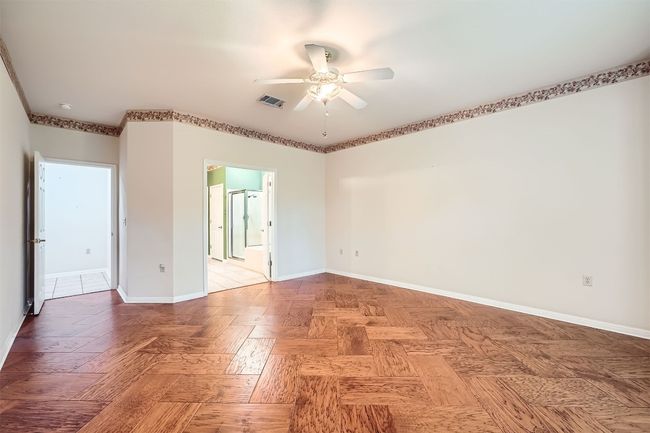 Spare room with a ceiling fan and baseboards | Image 16