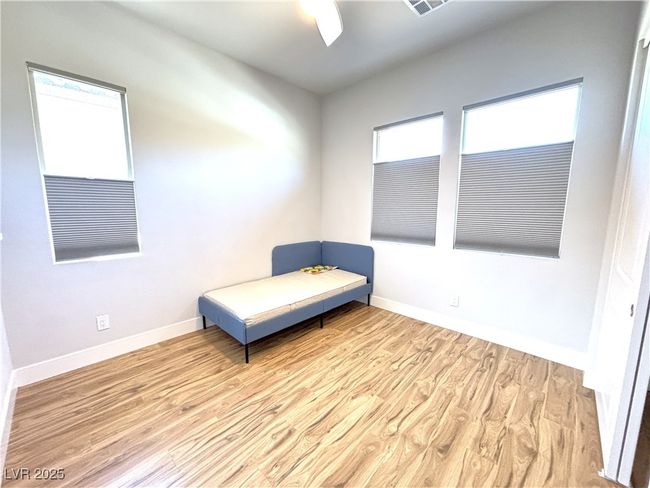 Sitting room with light wood-type flooring, a ceiling fan, and baseboards | Image 30