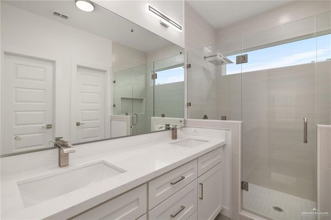 Full bathroom with double vanity and a stall shower | Image 9