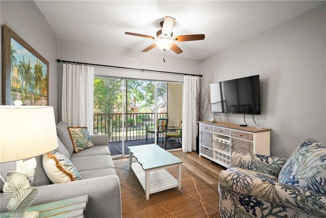 Living room with wood finished floors and a ceiling fan | Image 27