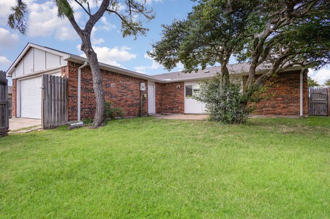 View of front of home with brick siding and an attached garage | Image 22