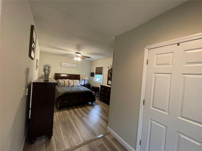 Bedroom featuring wood finished floors, baseboards, and a ceiling fan | Image 20