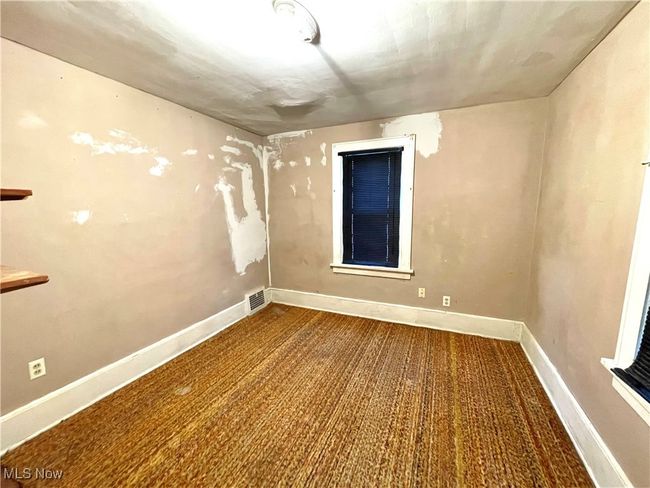 Unfurnished room with baseboards, visible vents, and carpet floors | Image 13