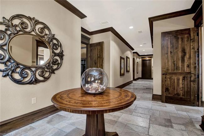 Hall with ornamental molding, stone tile floors, and recessed lighting | Image 42