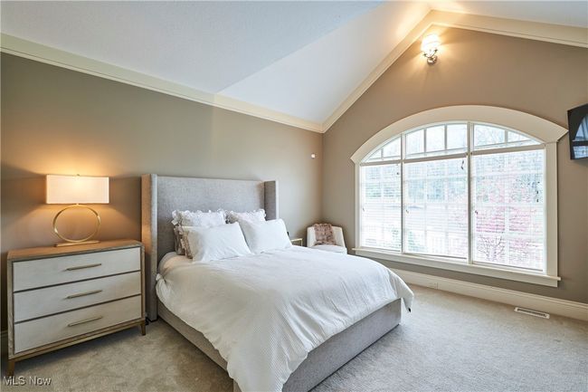 The second bedroom has vaulted ceiling with crown molding and newer paint and carpet | Image 18