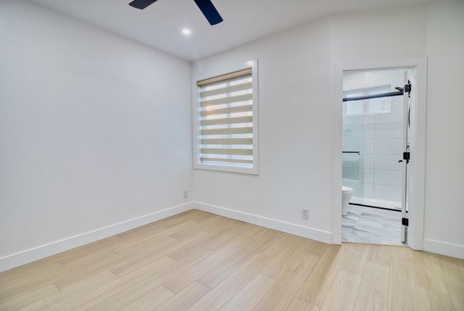 Empty room with a ceiling fan, light wood finished floors, baseboards, and recessed lighting | Image 17